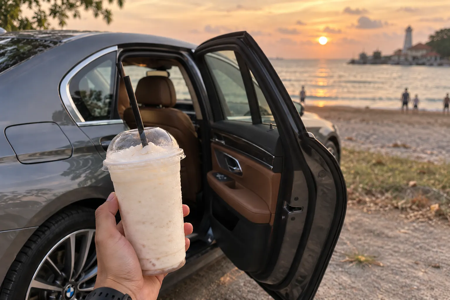Coconut shake beside the open door of a BMW 7 Series at one of the beaches in Melaka